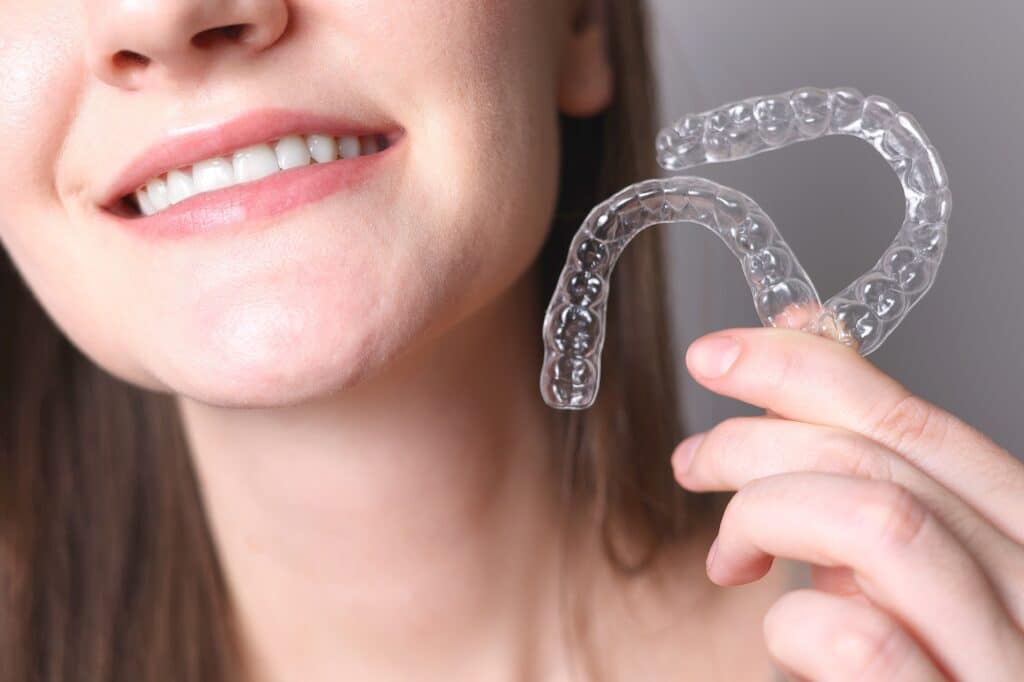 Smiling patient wearing Invisalign aligners at a dental clinic in Clearwater.
